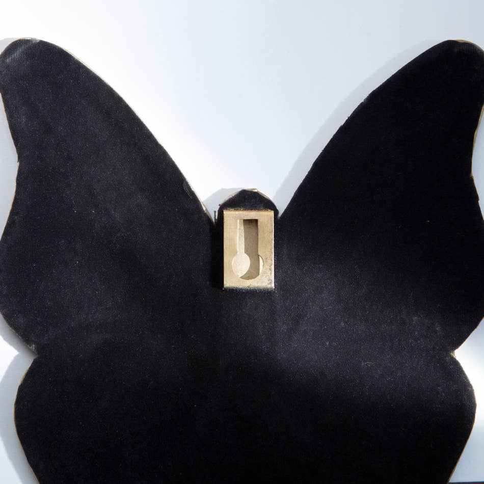 Miroir en forme de papillon avec détails en laiton
